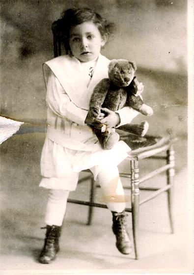 Harold as a small child, holding a teddy bear.