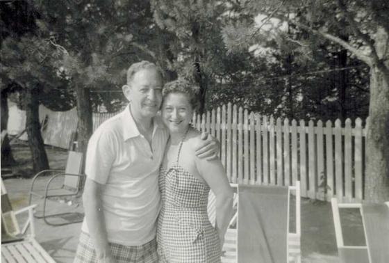 Harold and Mae by a picket fence.