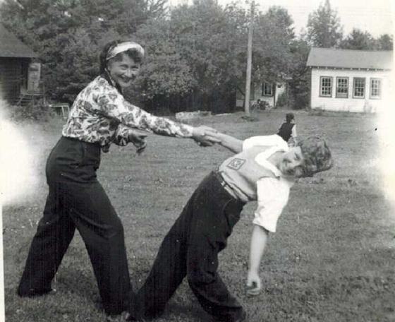 Mae and Warren on a lawn at what looks like a camp.