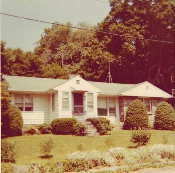 A small ranch house with shrubs and a TV antenna: the family’s summer house in Mahopac, N.Y.