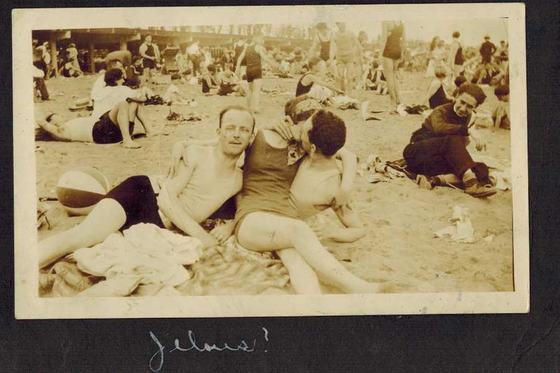 Harold and Mae kissing on a beach blanket, a beach ball beside them.