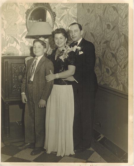 Harold in a tuxedo with Mae in a sequined top and long pleated skirt, and their son Warren as a boy in a tweed jacket and patterned tie.
