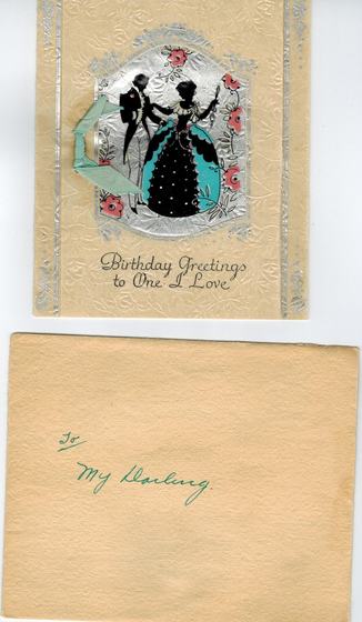 A birthday card, “Birthday Greetings to One I Love,” with a silhouette couple and a green ribbon, and its envelope, marked in green ink “To my darling.” The card is to Mae.
